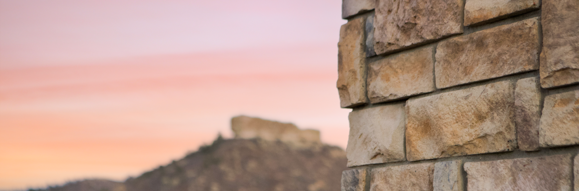 sunset stone headquarters with castle rock in background